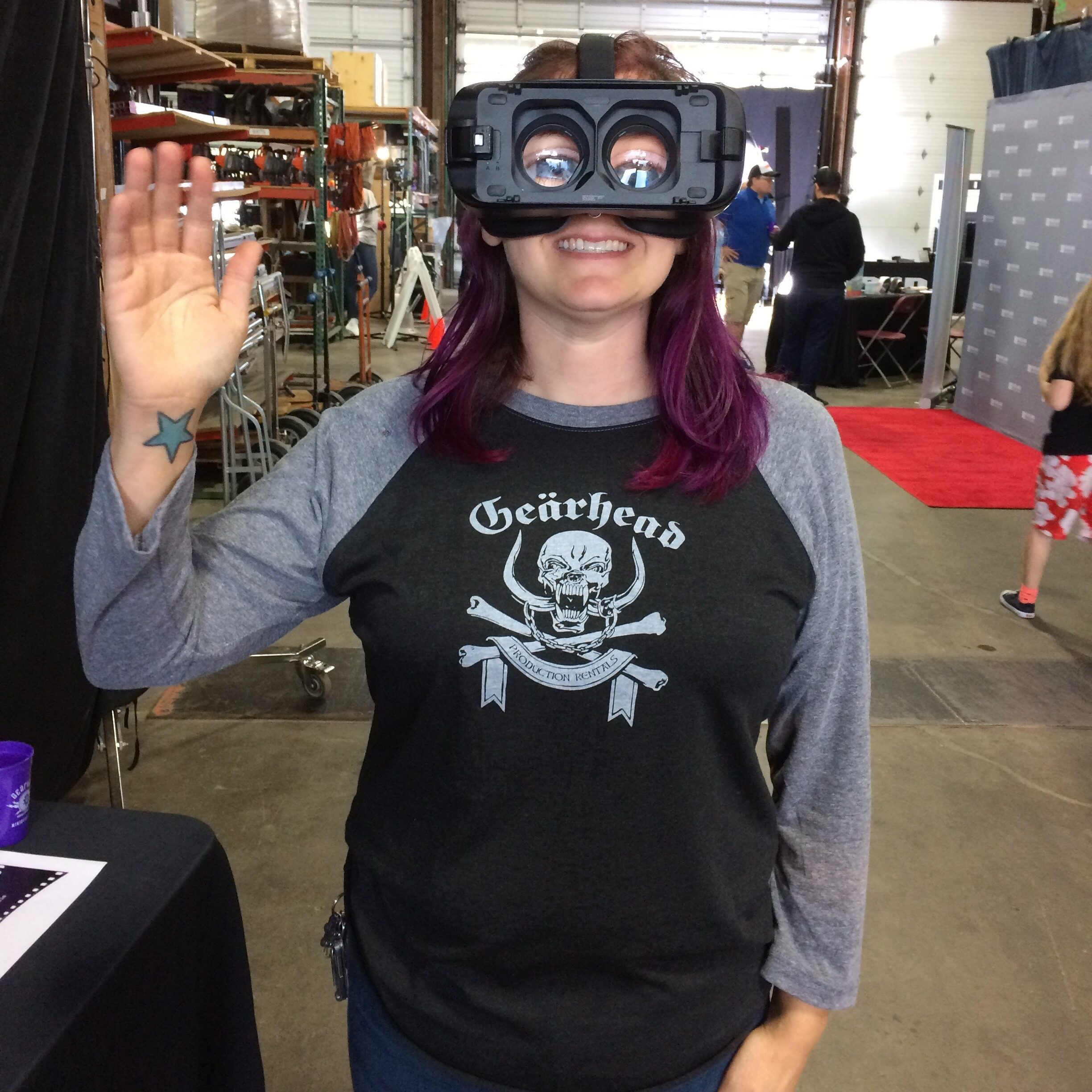 Gearhead Rentals Manager Tiffany Lindquist waves hello while wearing a VR headset.
